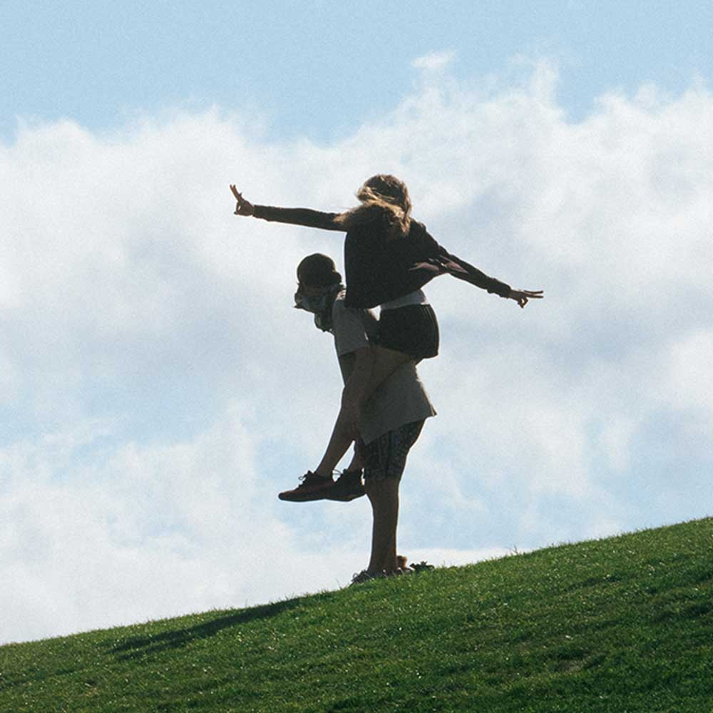 two coachella fans on hill