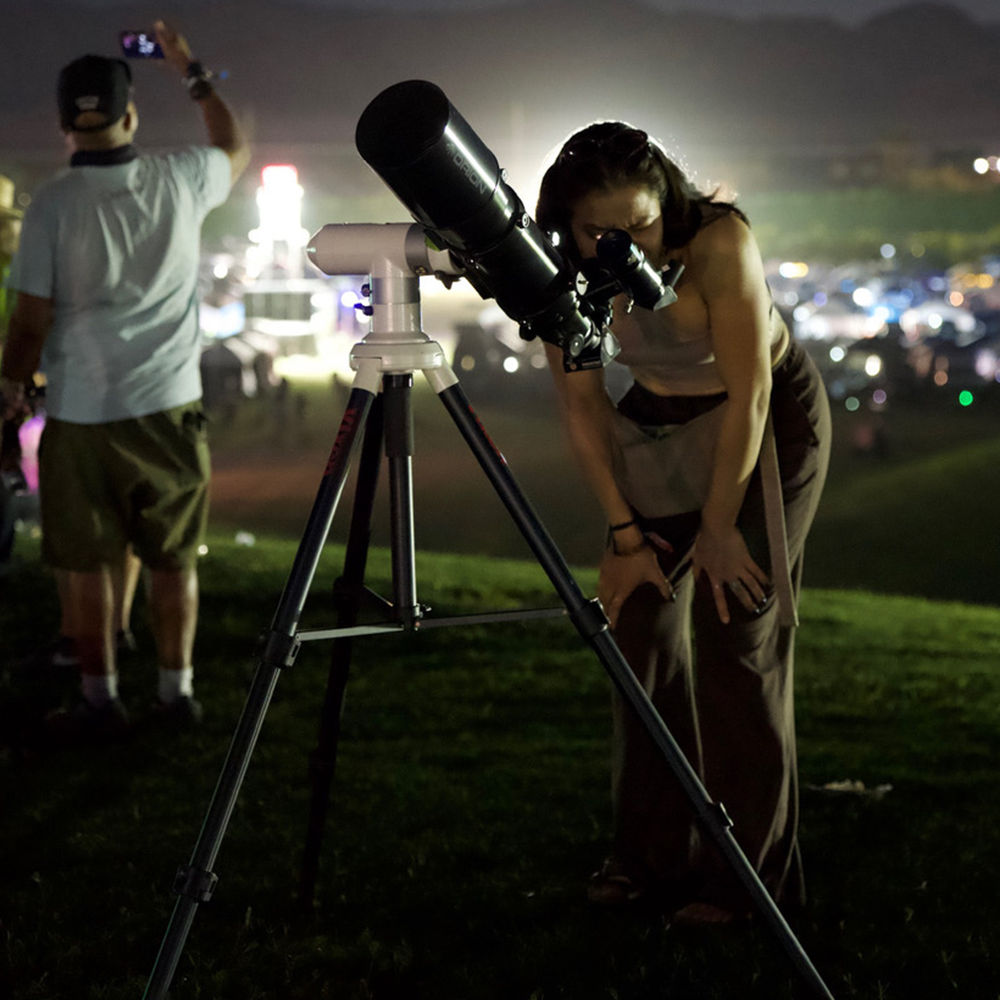 Woman looking through telescope