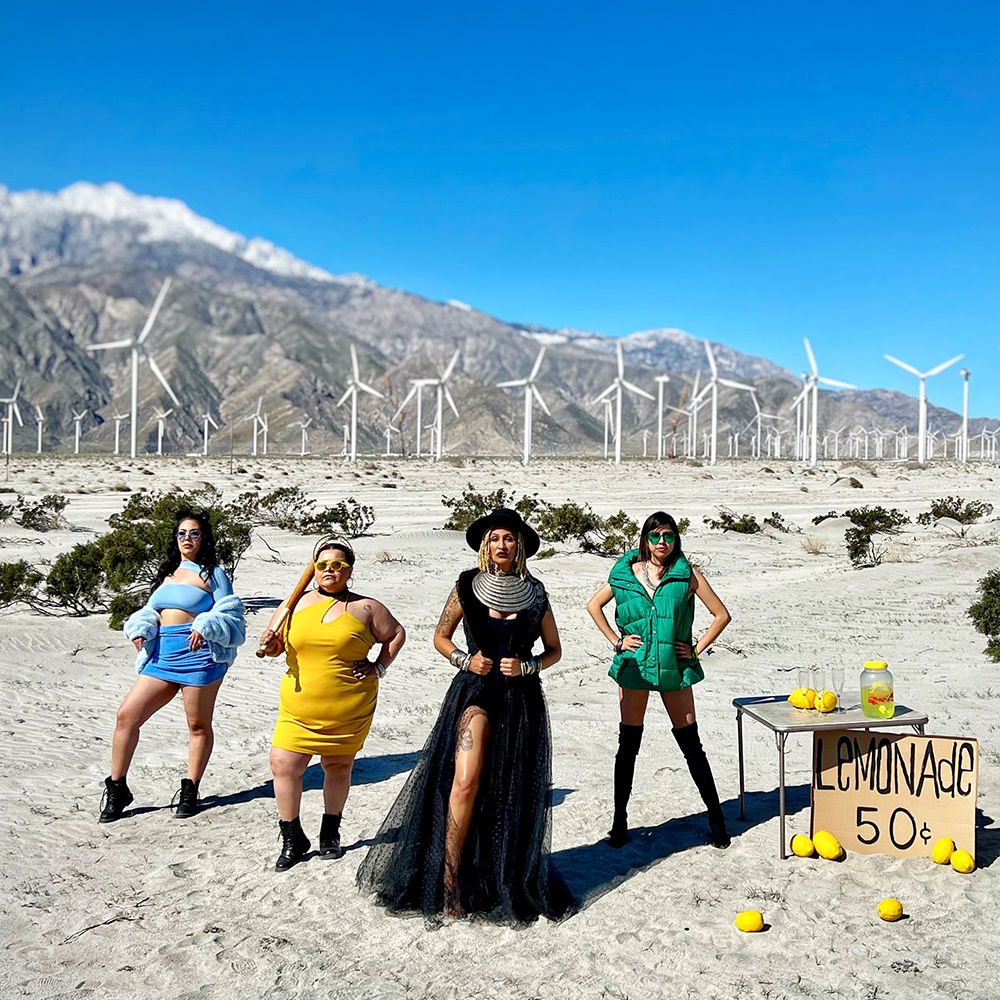Women next to lemonade stand in the desert