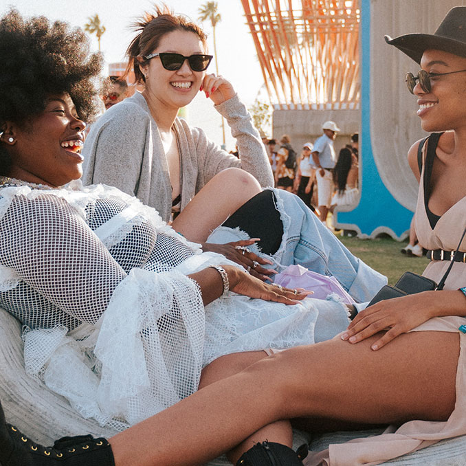 Coachella fans sitting on grass and hanging out