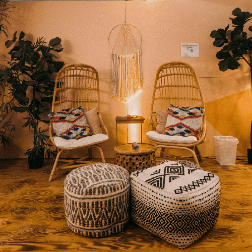 Photo of relaxing nook with bamboo chairs and ottomans