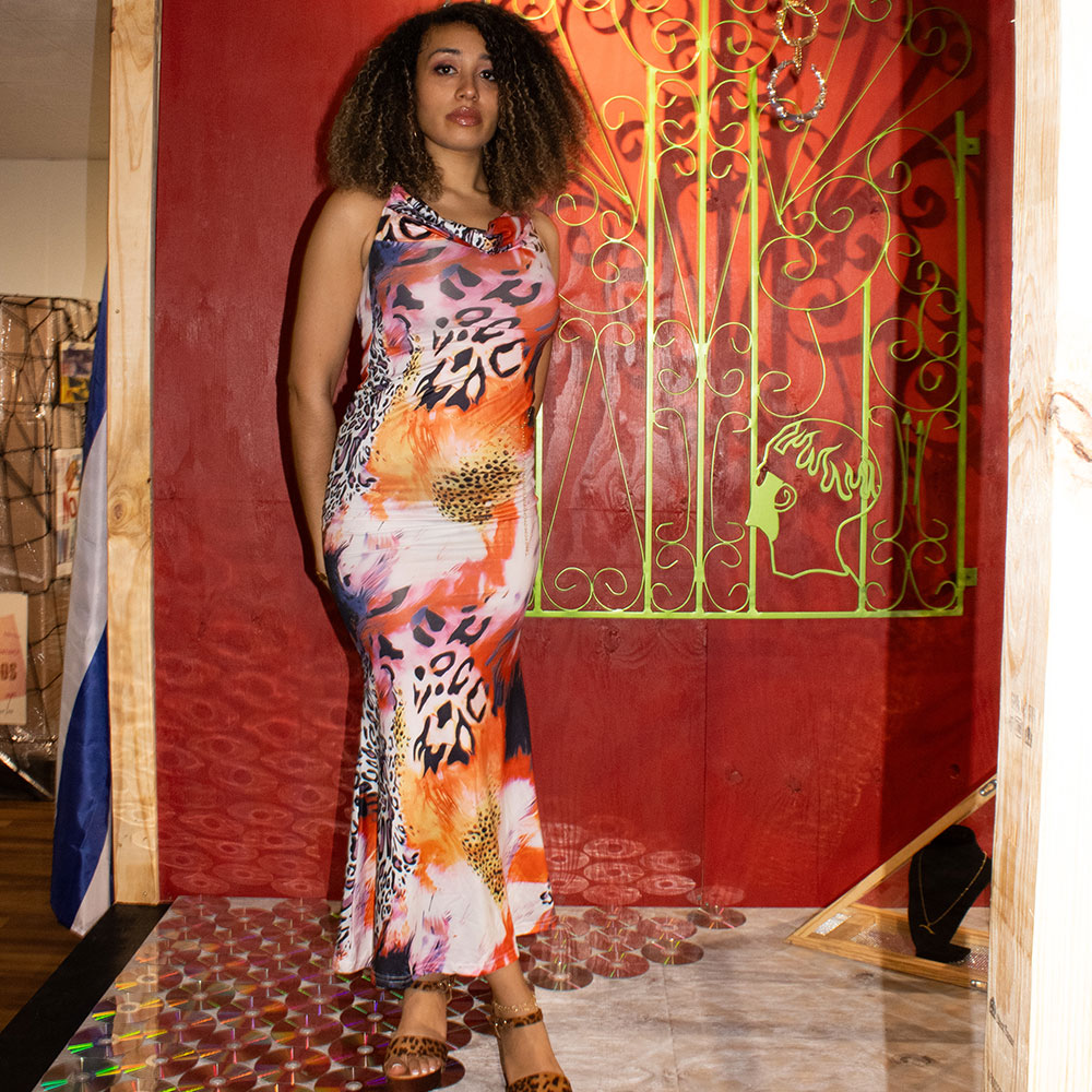 Sydney Rose in front of red wall