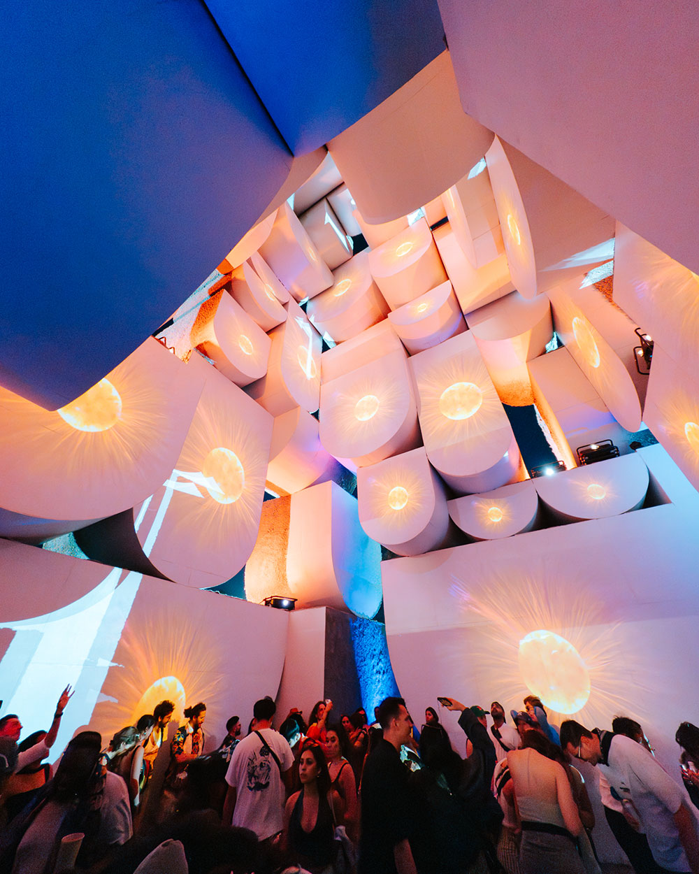 Coachella festivalgoers in front of art installation at night