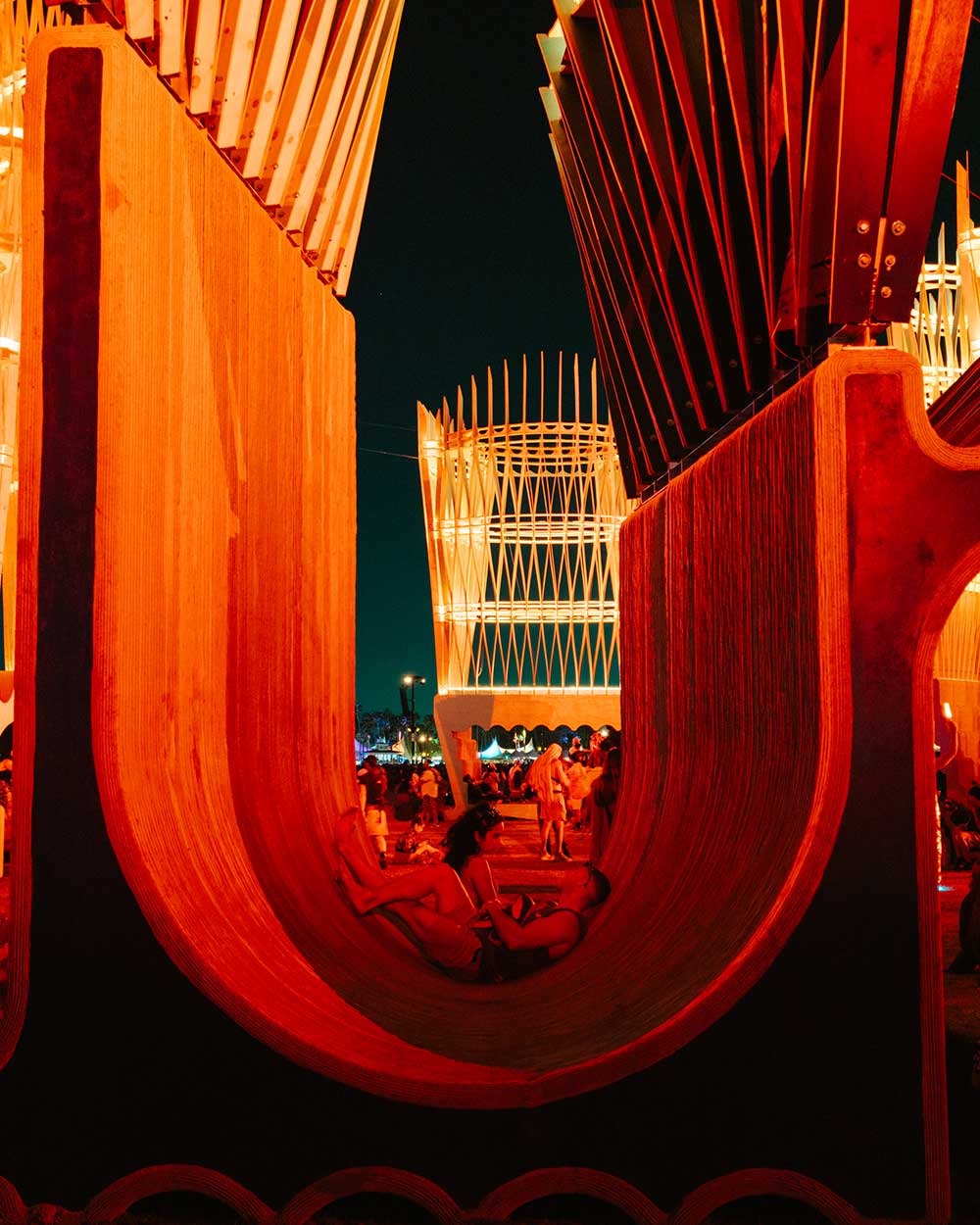 fans lounging on art installation