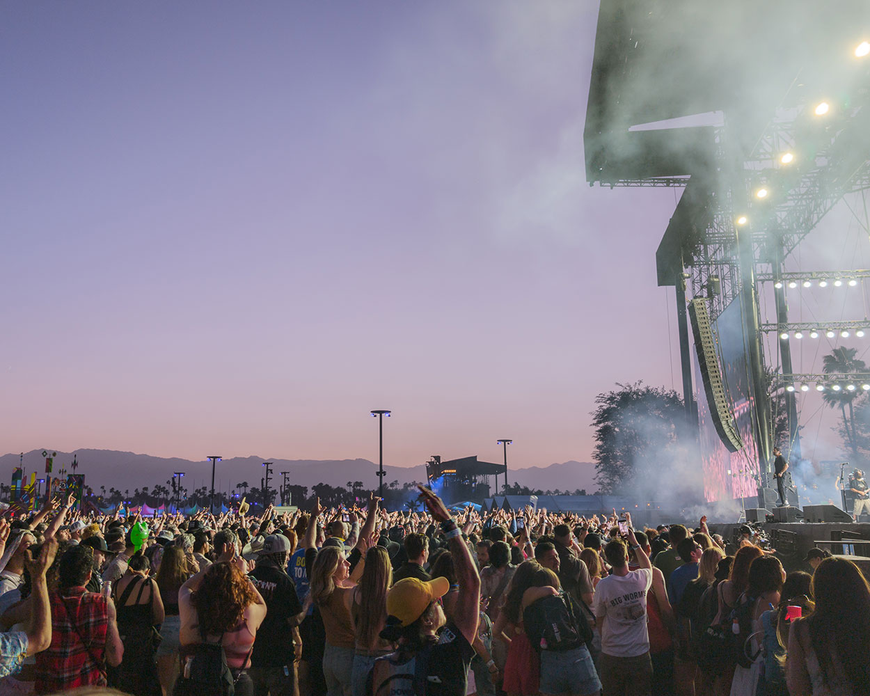 Crowd shot in front of stage at dusk