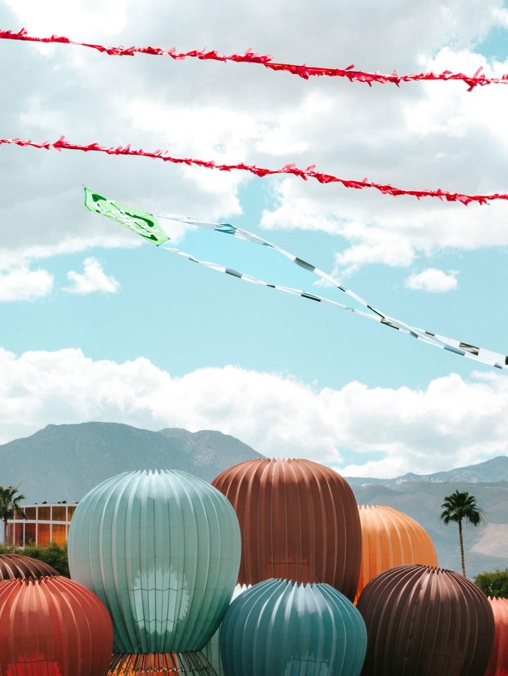 balloon chain against clouds and blue sky