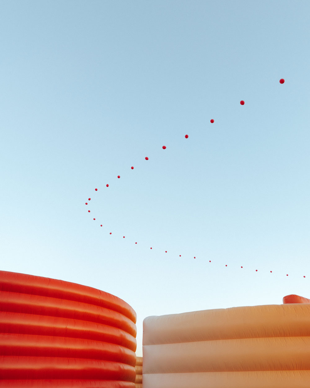 balloon chain against blue sky