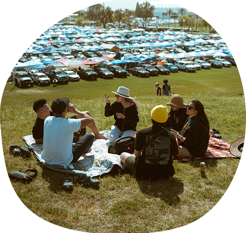 Coachella campers sitting on grass